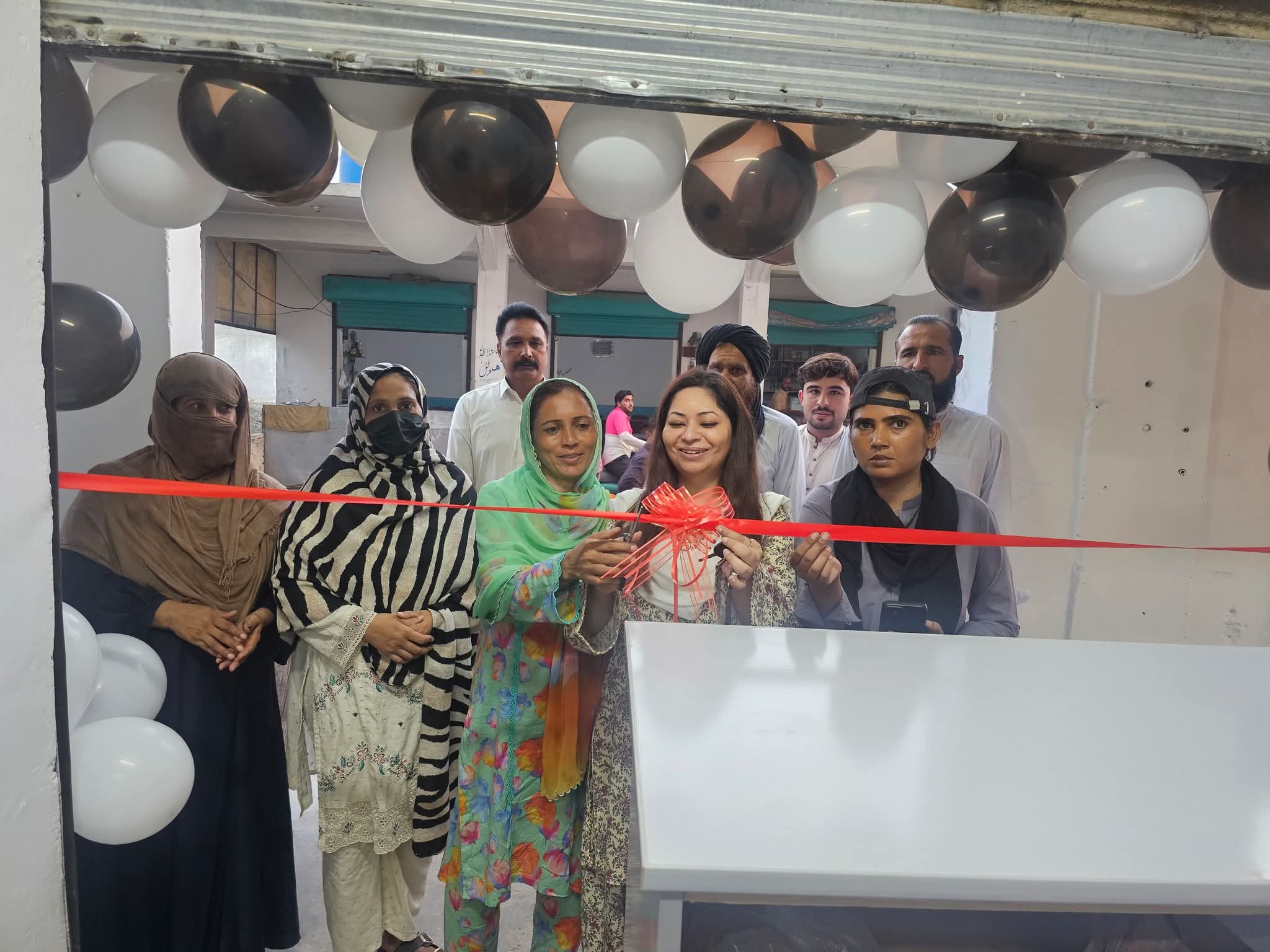 A group gathered for a ribbon-cutting ceremony